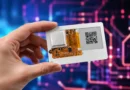 Ruka drži ultra-tanku MuxCard razvojnu ploču sa e-ink ekranom i vidljivom elektronikom
